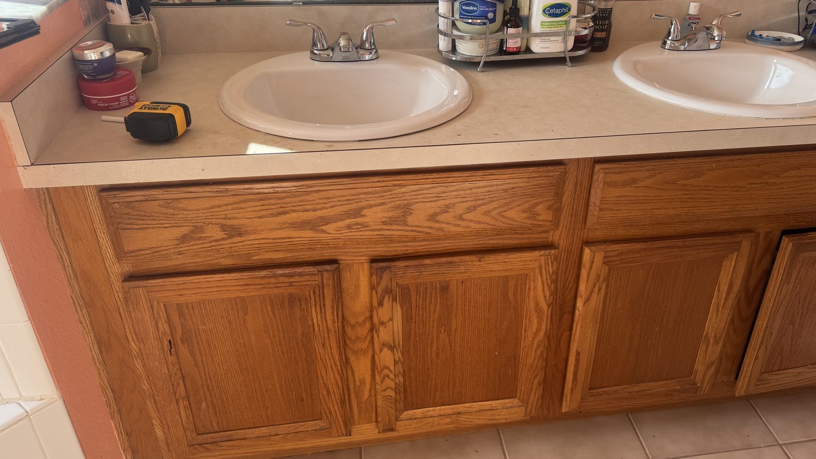 Dated oak bathroom vanity with cultured marble top before remodeling