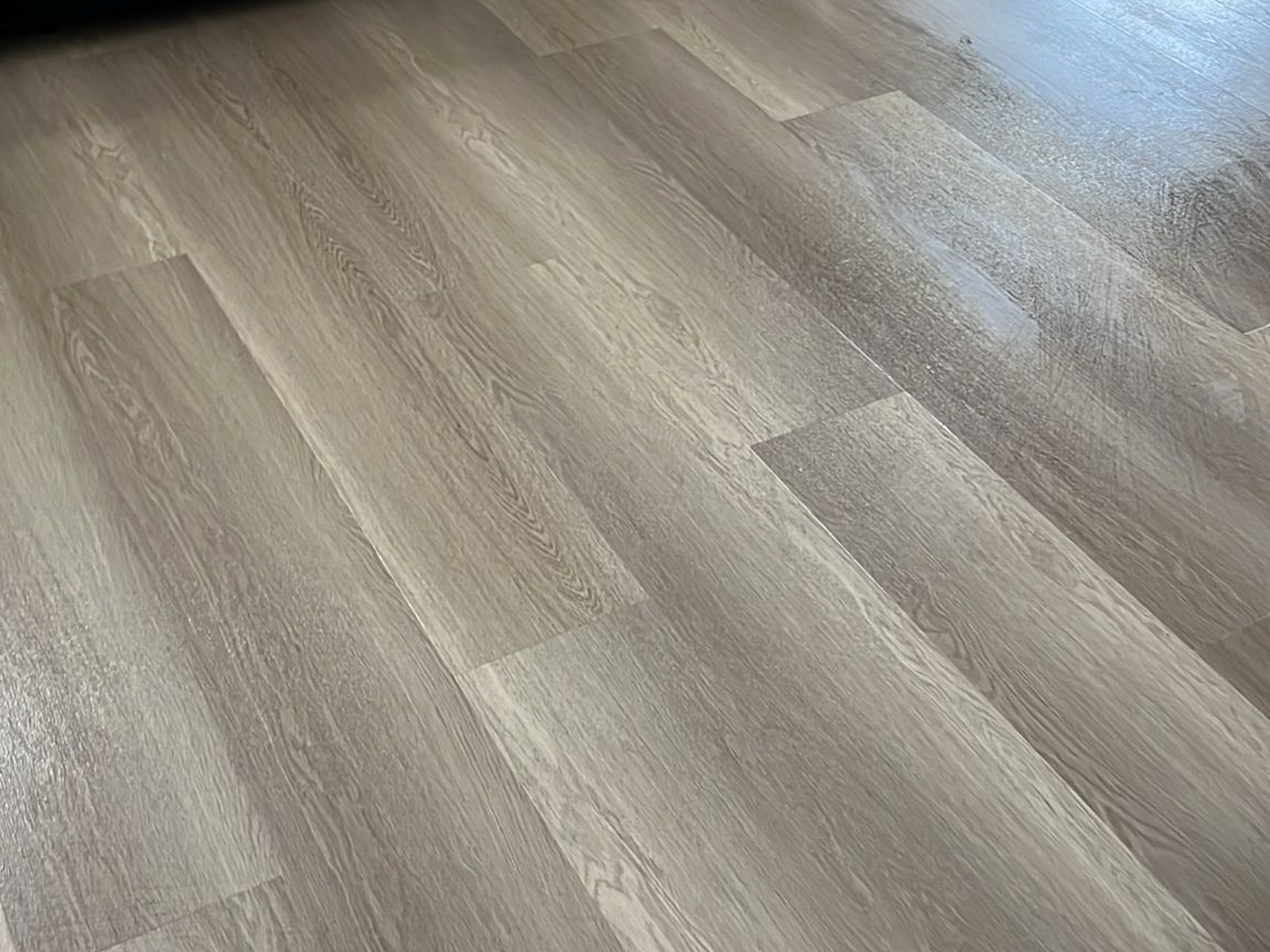 Luxury vinyl plank flooring installed in a Kissimmee home, grey oak finish