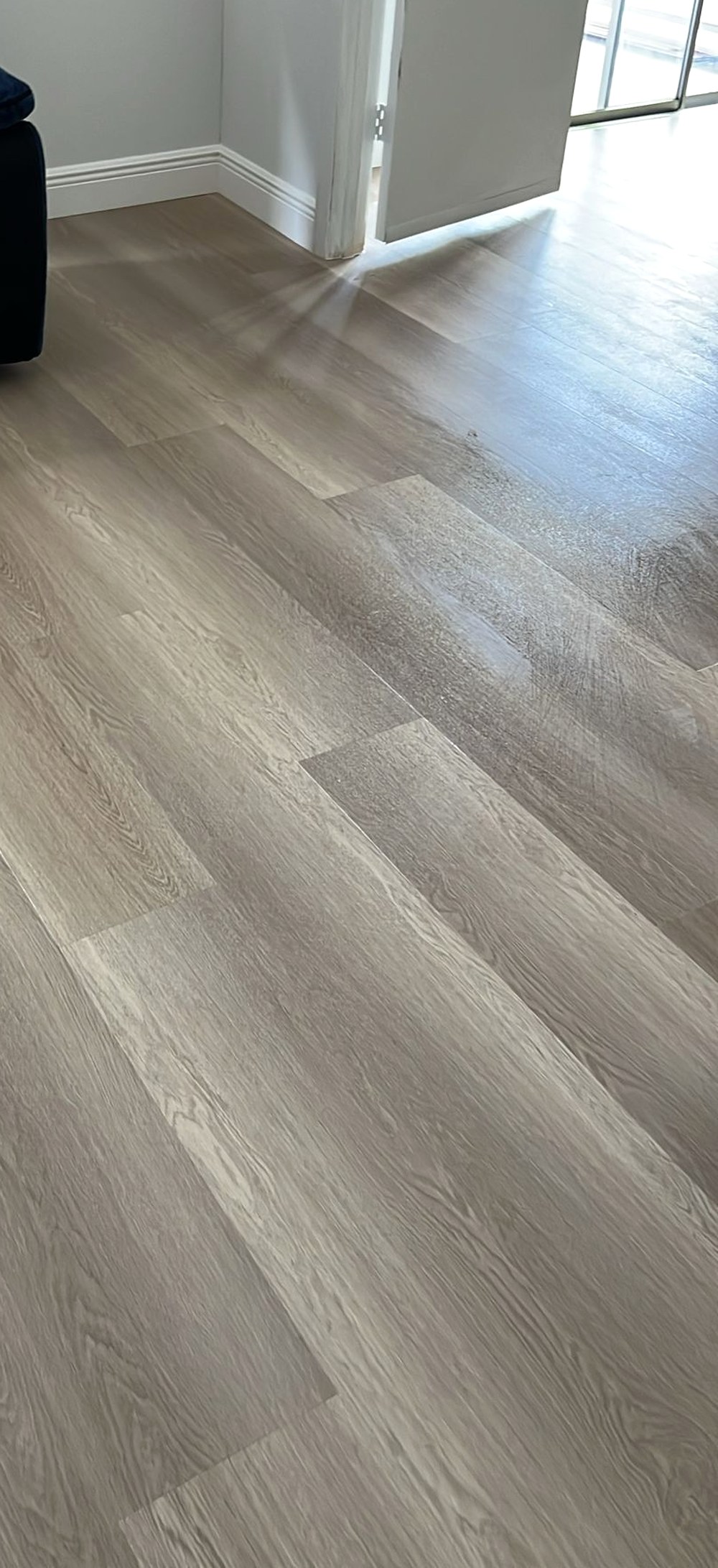 Luxury vinyl plank flooring running through a doorway into the next room, a Kissimmee install