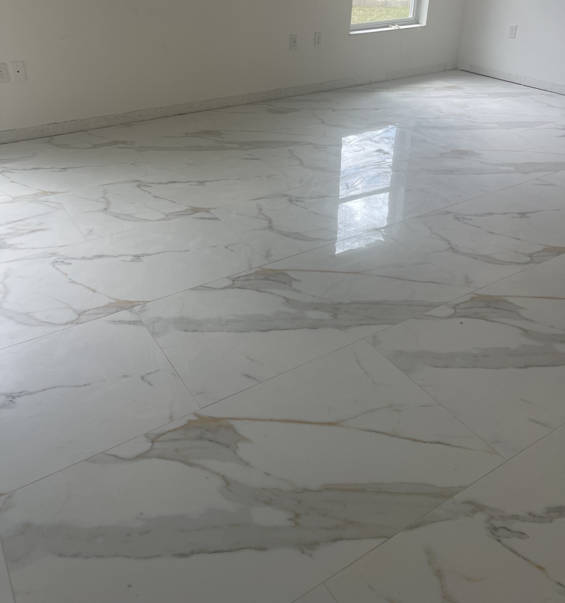 Calacatta porcelain tile flooring installed wall to wall