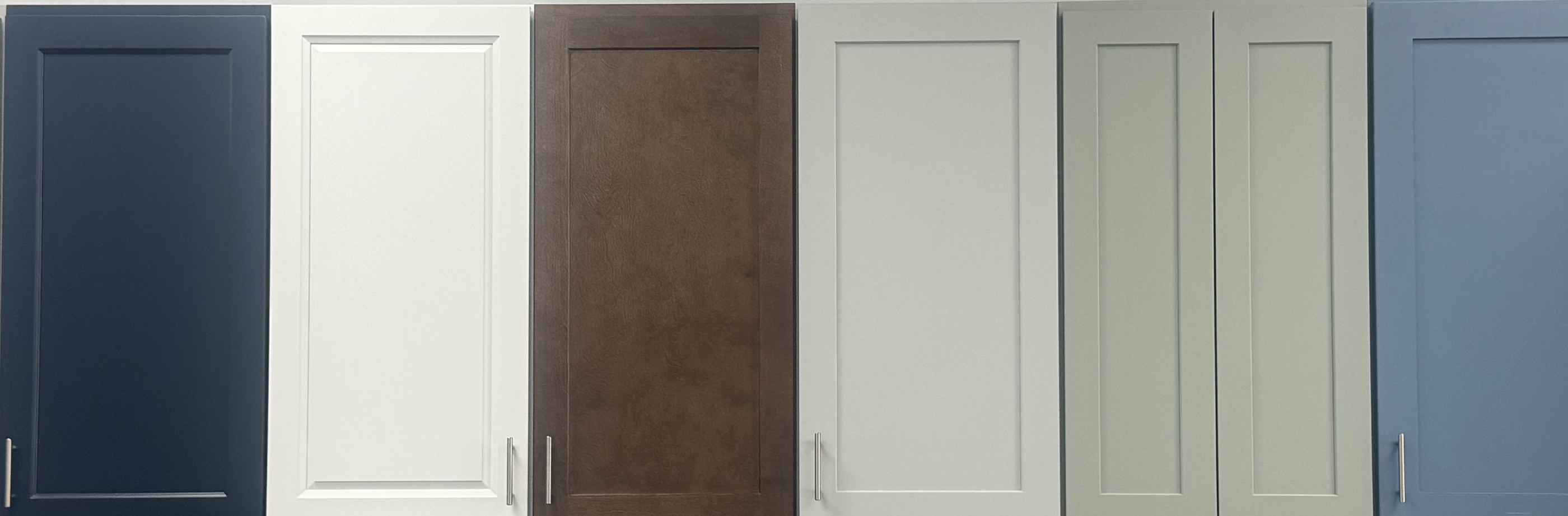 Six cabinet door samples on display at the Xclusive Floors showroom in Kissimmee
