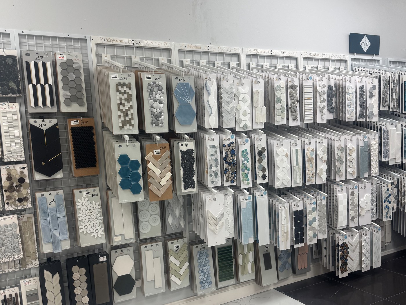 Backsplash wall at the Xclusive Floors showroom with hundreds of mosaic tile samples
