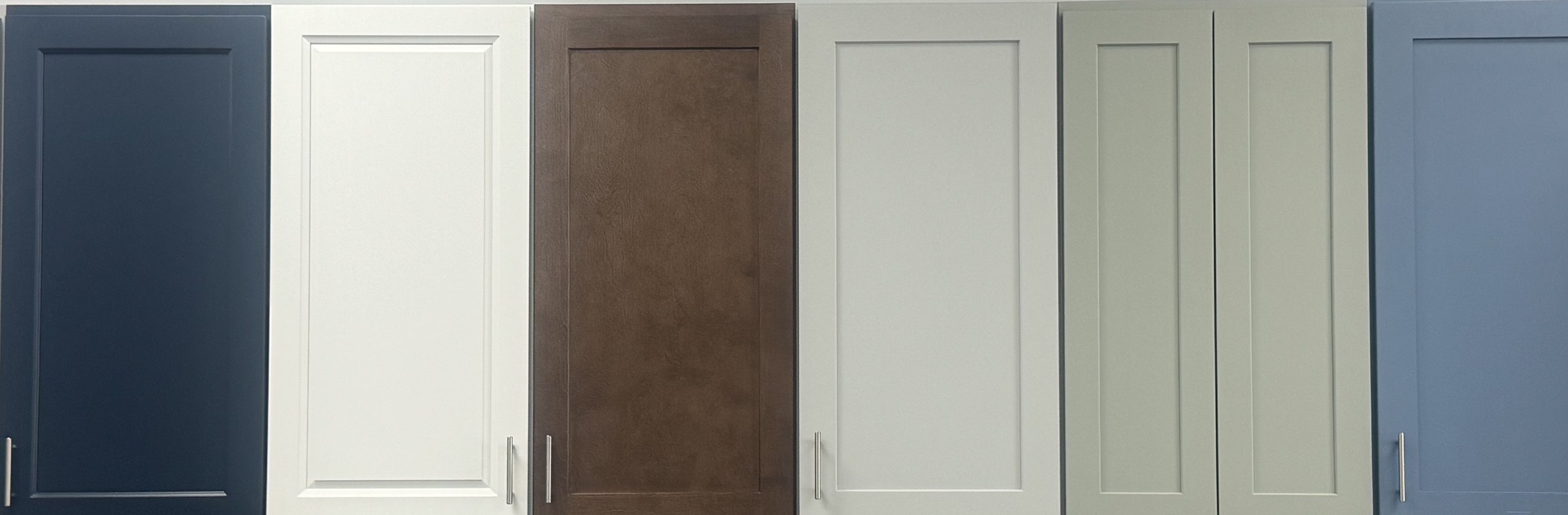 Row of six cabinet door samples on display at the Xclusive Floors showroom in Kissimmee