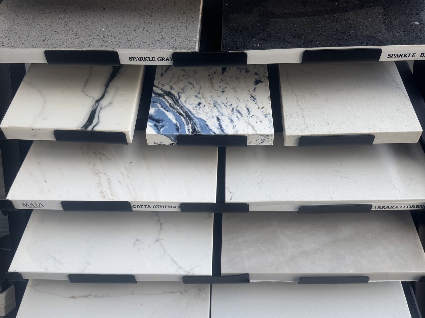 Quartz countertop samples on labeled pull-out shelves
